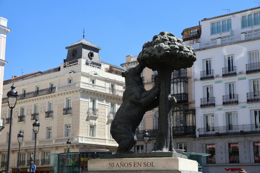 Iconic Bear and Strawberry Tree statue in Madrid's bustling Puerta del Sol.